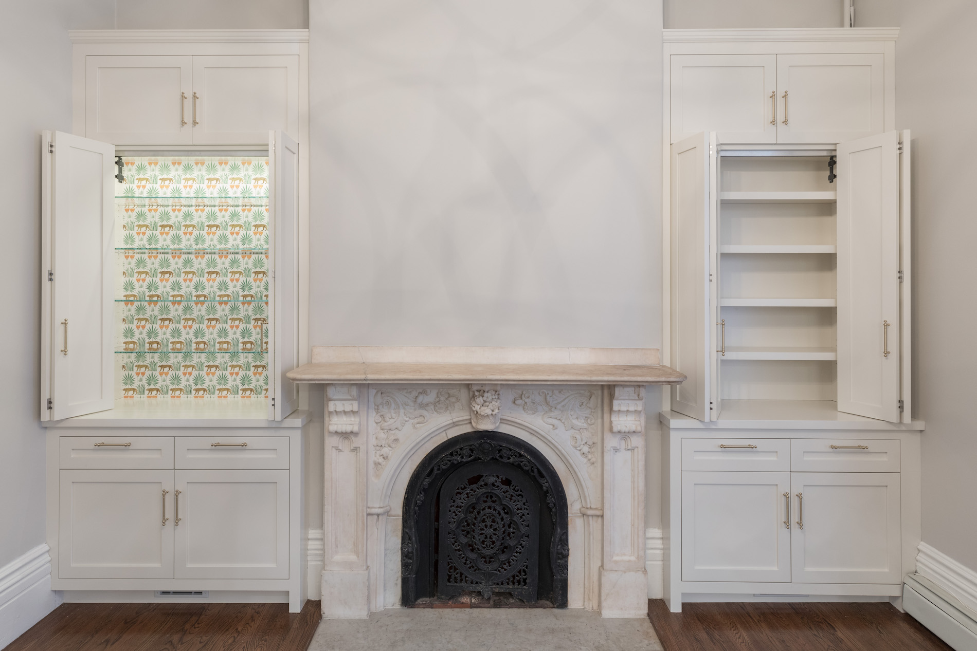Parlor with marble mantel and white built-in cabinetry