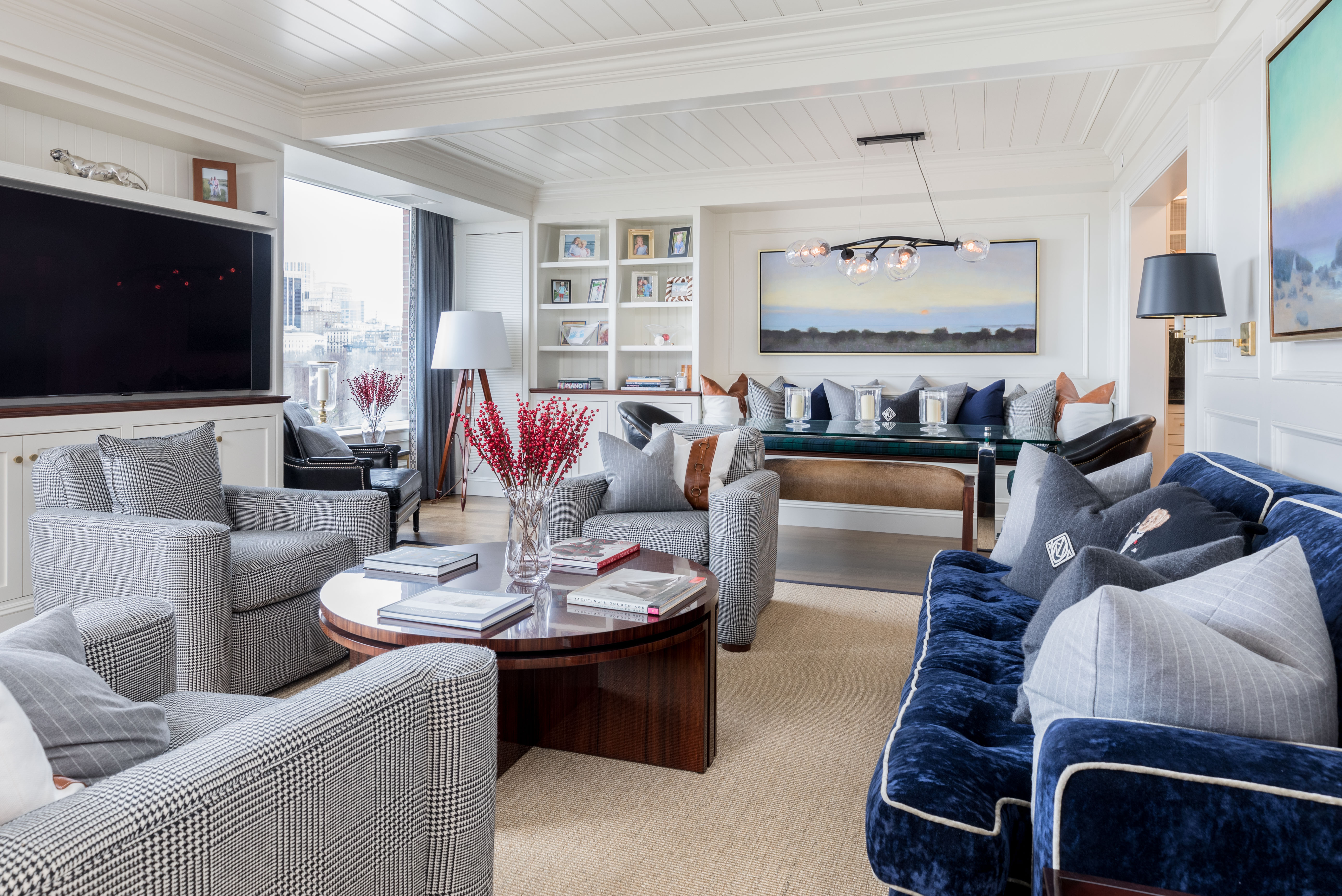Living room with blue velvet sofa and coastal art